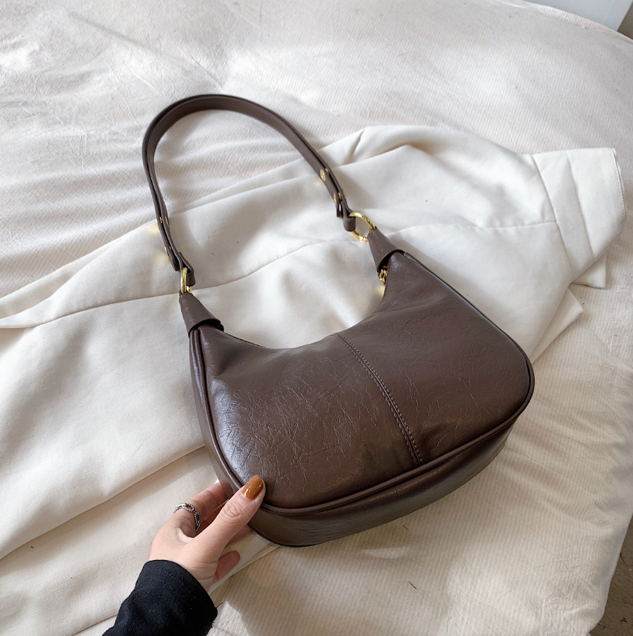 Women's structured crescent hobo bag with zip-top closure and polished gold hardware for everyday use