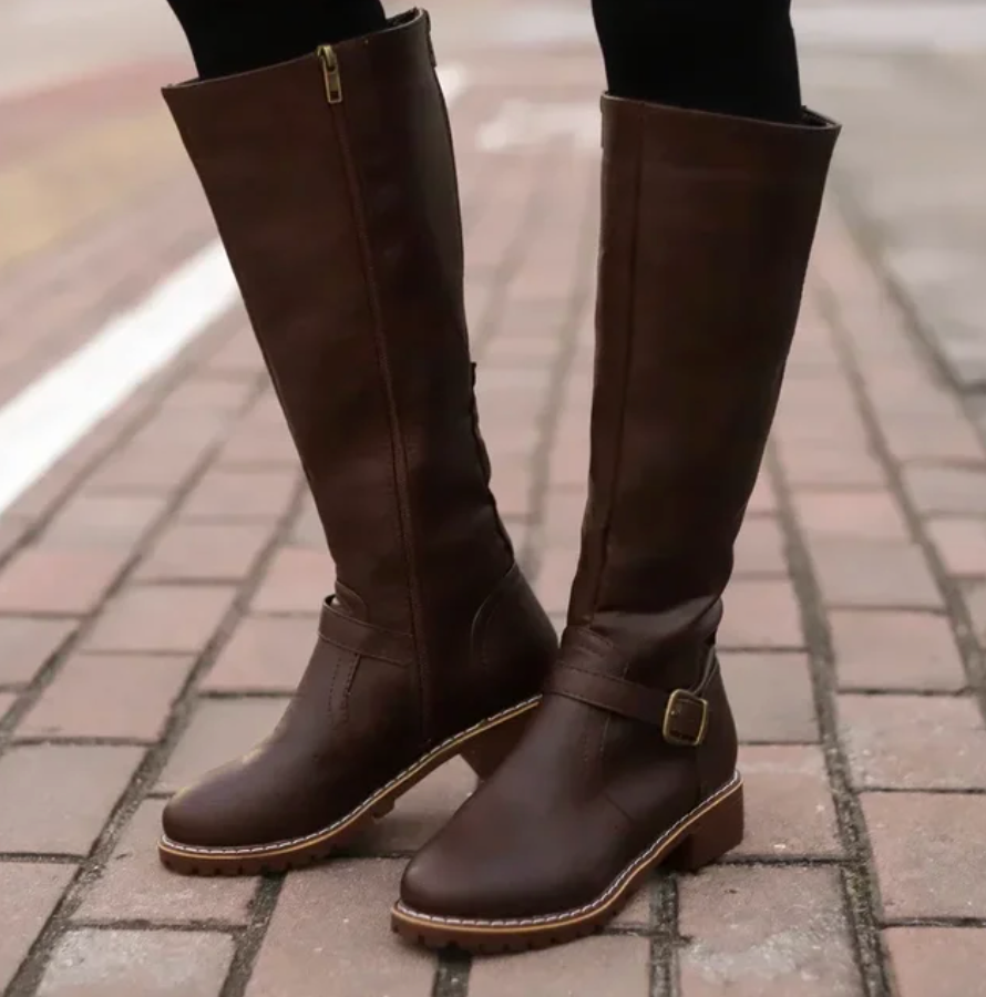 Women's black knee-high boots with buckle strap, low block heel and textured grip sole