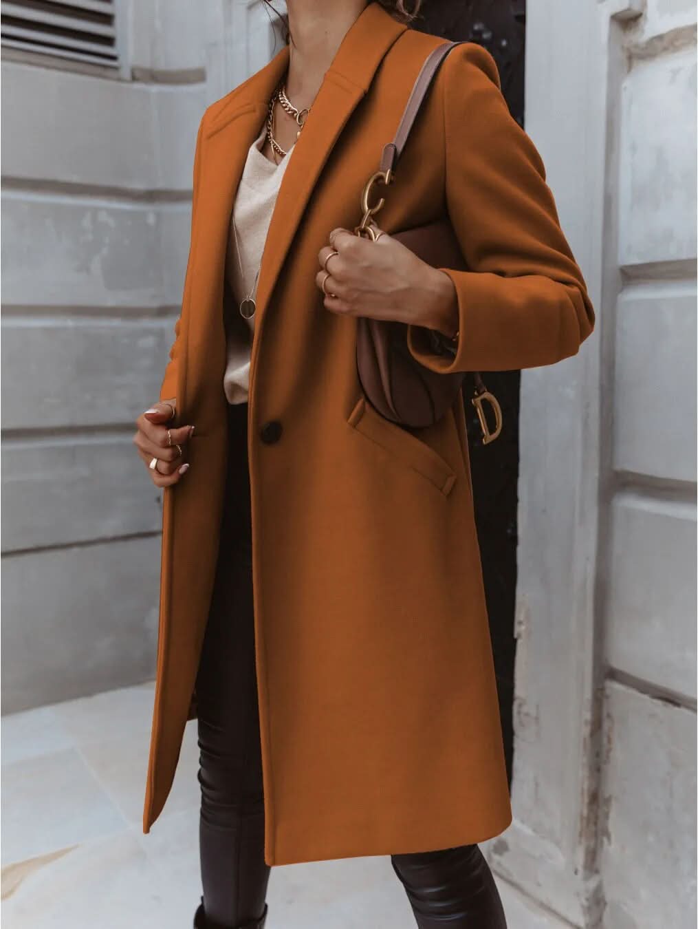 Women's long tailored overcoat structured shoulders minimalist design elegant smart layering essential