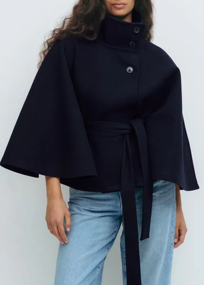 Women's beige belted high-neck cape coat with figure-flattering silhouette and chic spring style