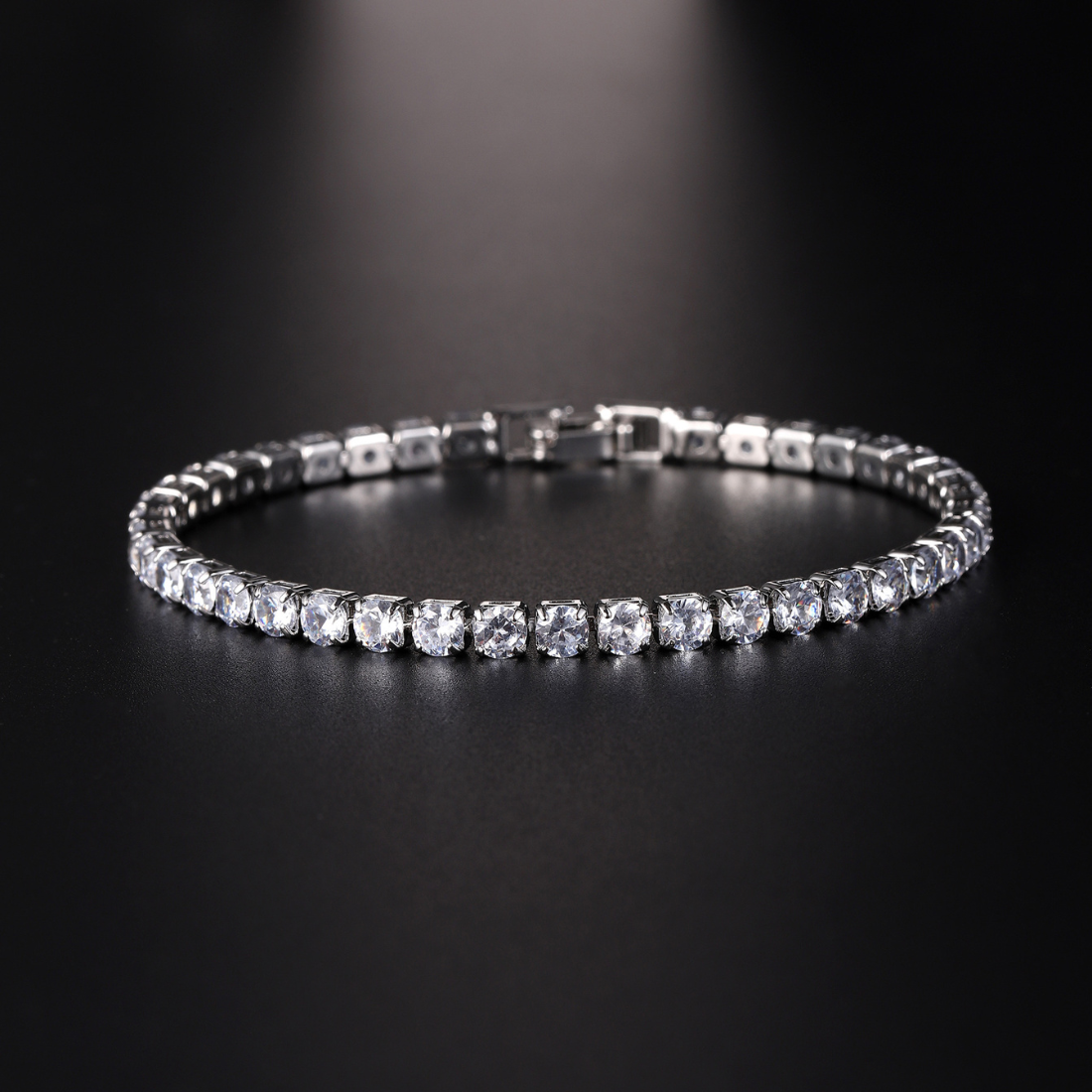 Silver slim-line round-cut tennis bracelet with secure box clasp for everyday elegance