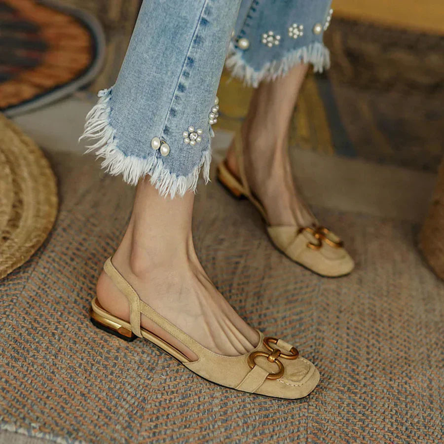 Nude suede slingback flats with cushioned insole, ergonomic design and gold hardware accents