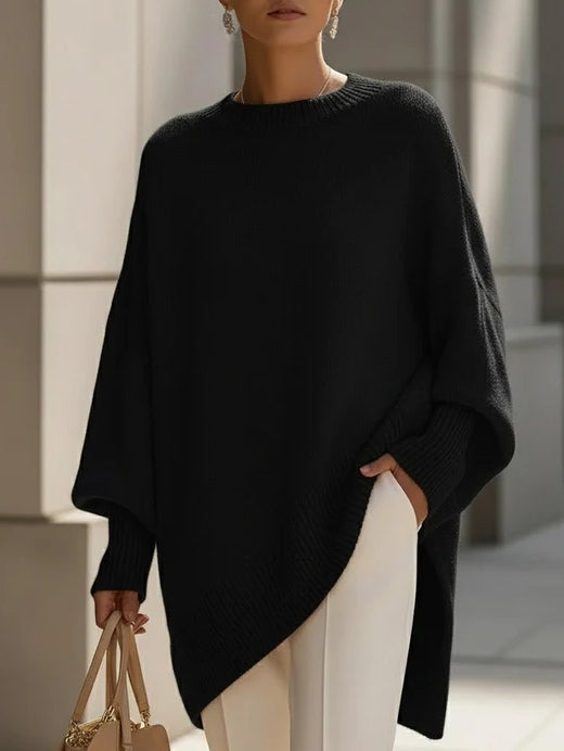 Women's oversized cozy sweater in neutral tones with flowing drape silhouette and effortless elegant fit