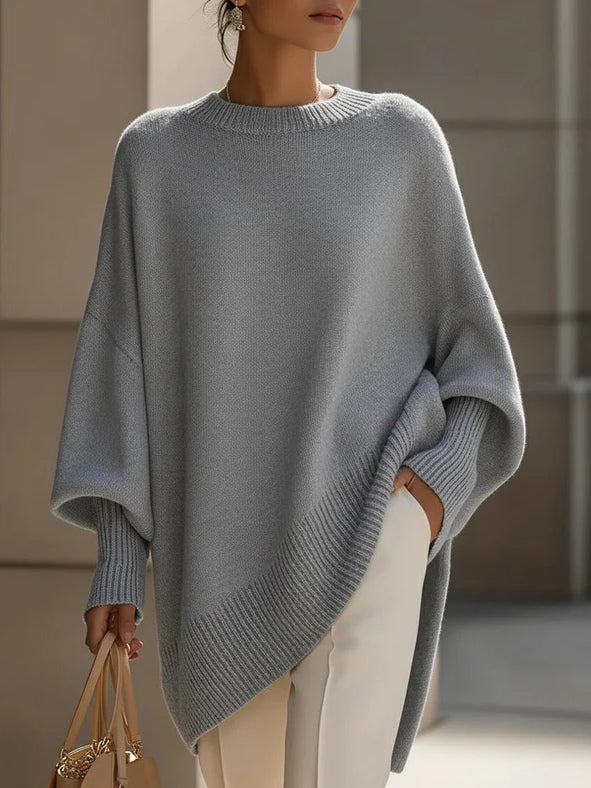 Women's oversized cozy sweater in neutral tones with graceful draping silhouette for everyday luxe style