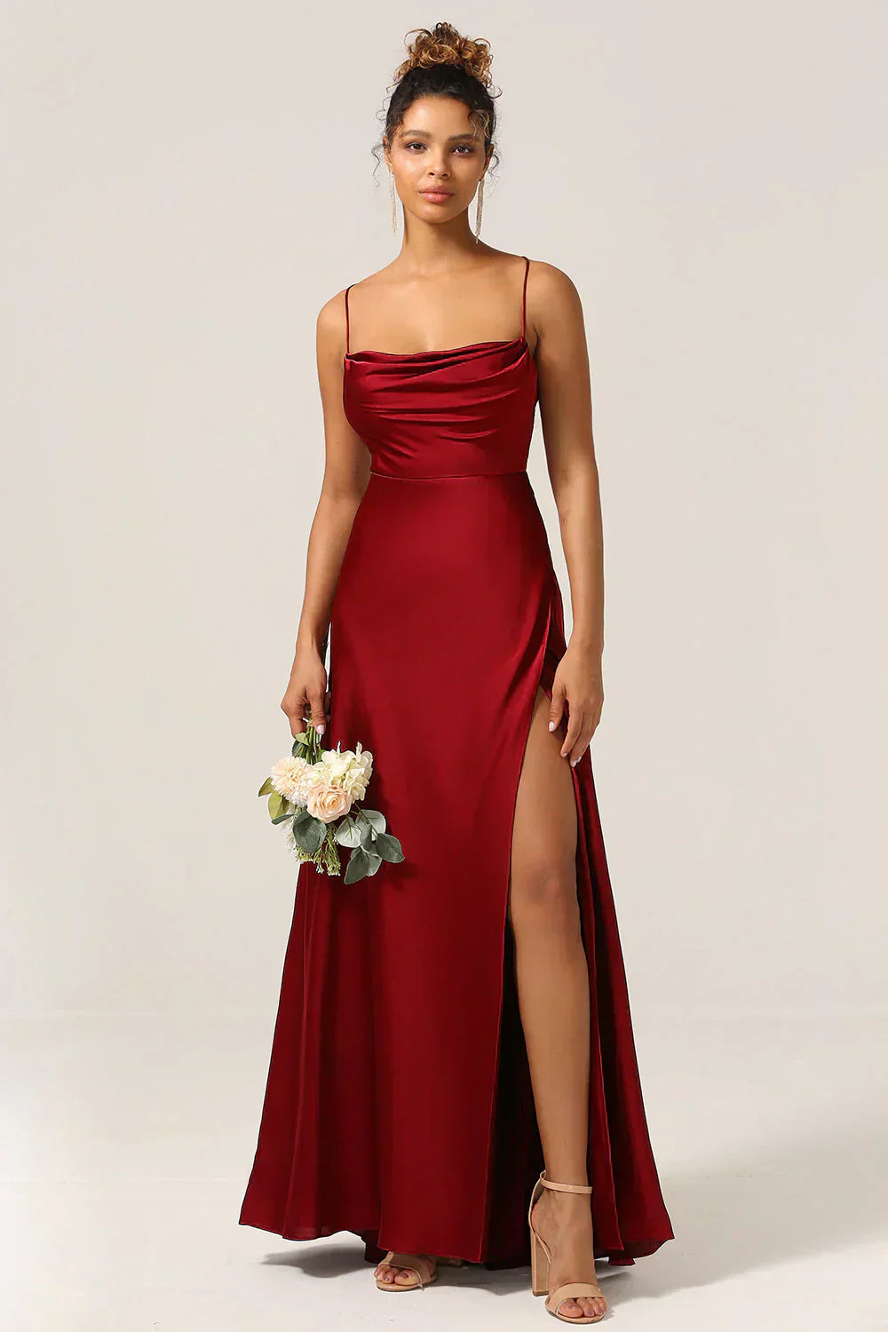 Elegant satin evening gown with draped neckline, spaghetti straps, and sleek formal silhouette