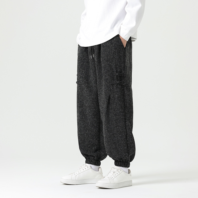 Light beige minimalist joggers with tapered cut and traditional side knot details in soft breathable fabric