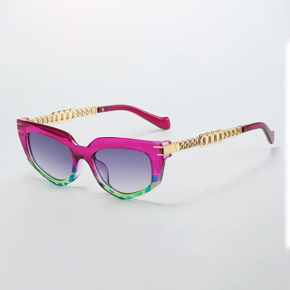 Bold chunky cat-eye sunglasses with green ombré tips, gradient brown lenses, and gold chain-link arms