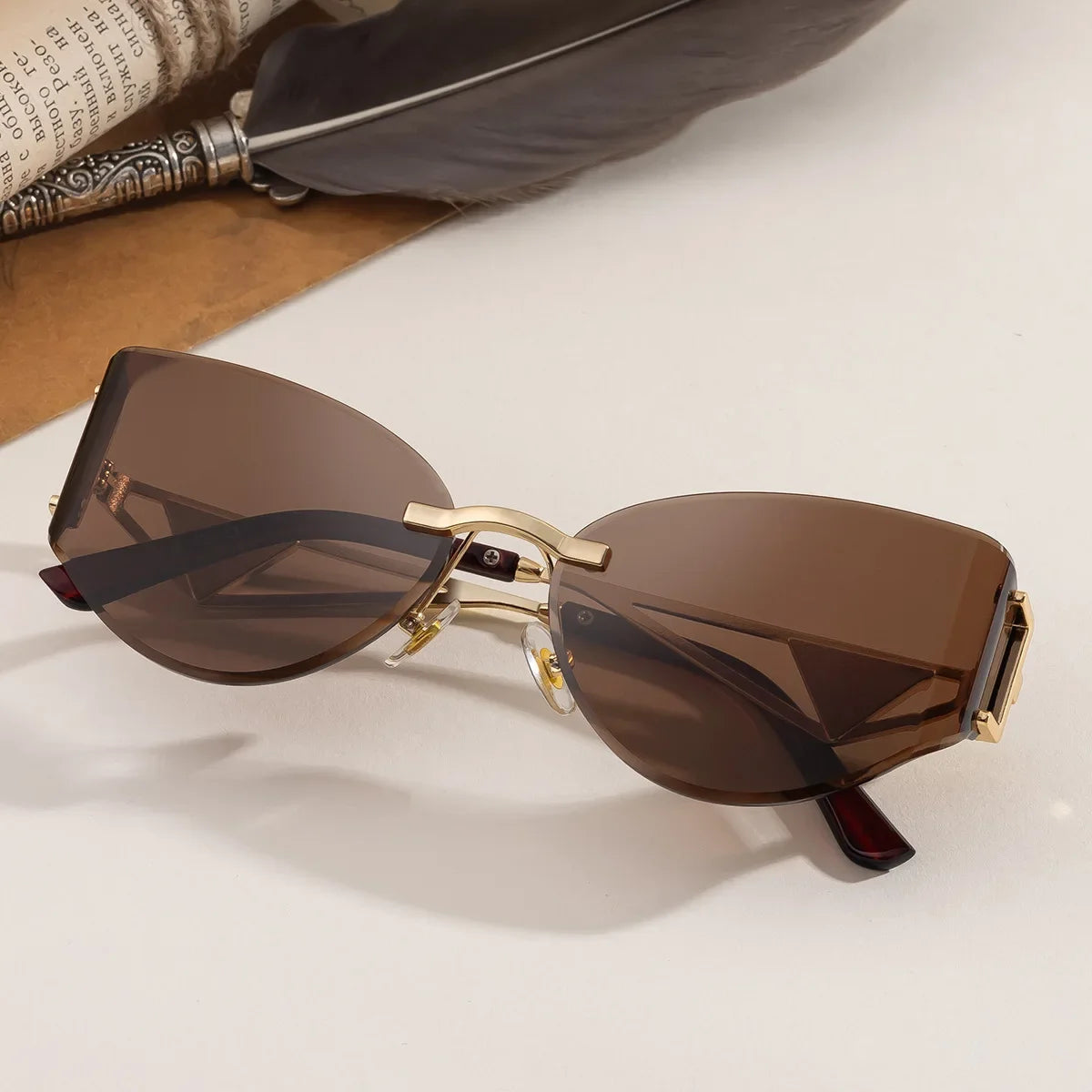 Rimless cat-eye sunglasses geometric metal arms UV protection bold architectural women's fashion