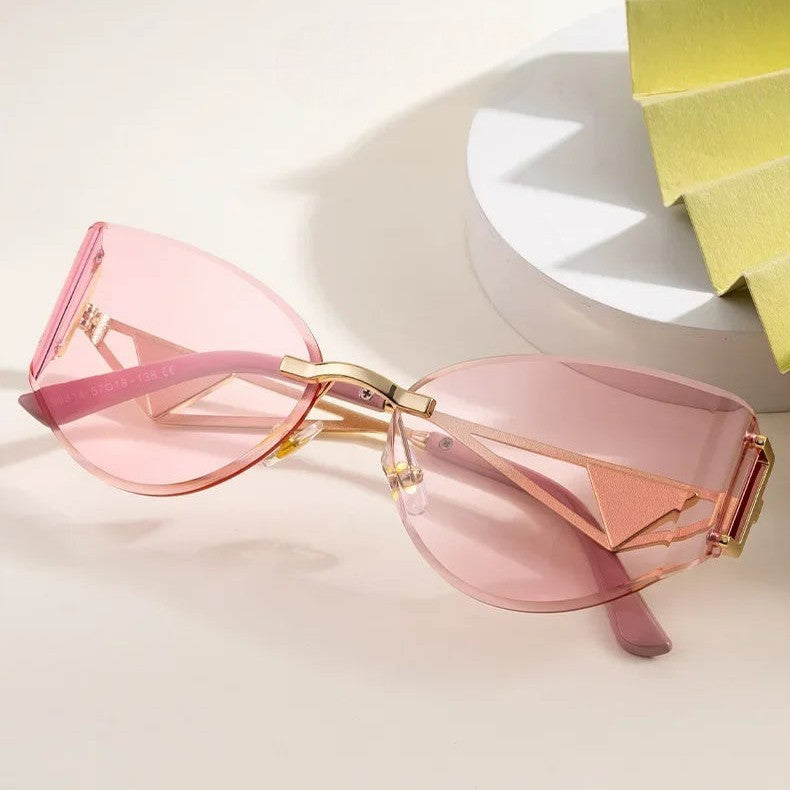 Rimless cat-eye sunglasses geometric metal temples UV protection bold architectural women's fashion