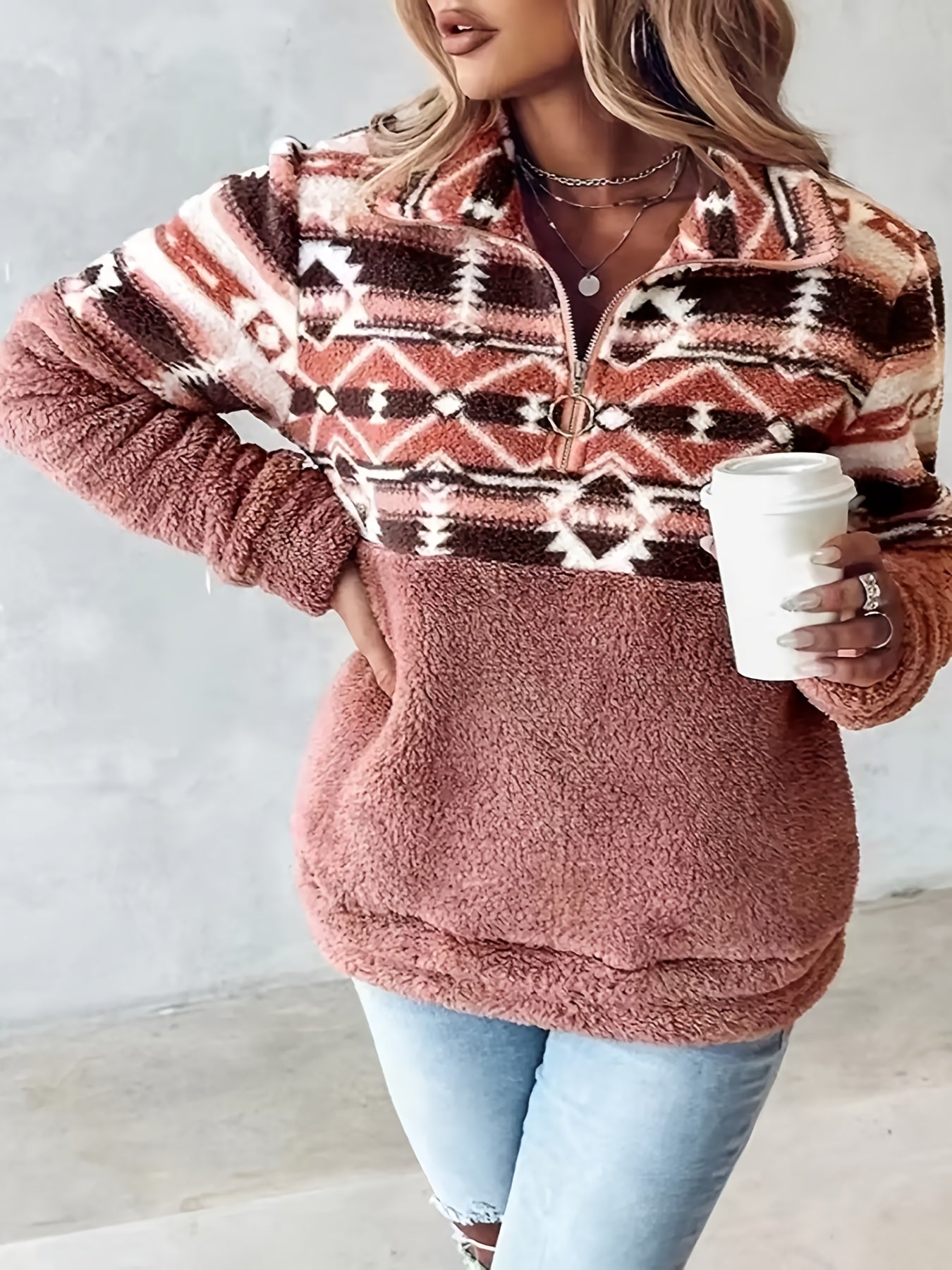 Casual fleece half-zip sweater with Aztec pattern accent and kangaroo pocket for winter warmth