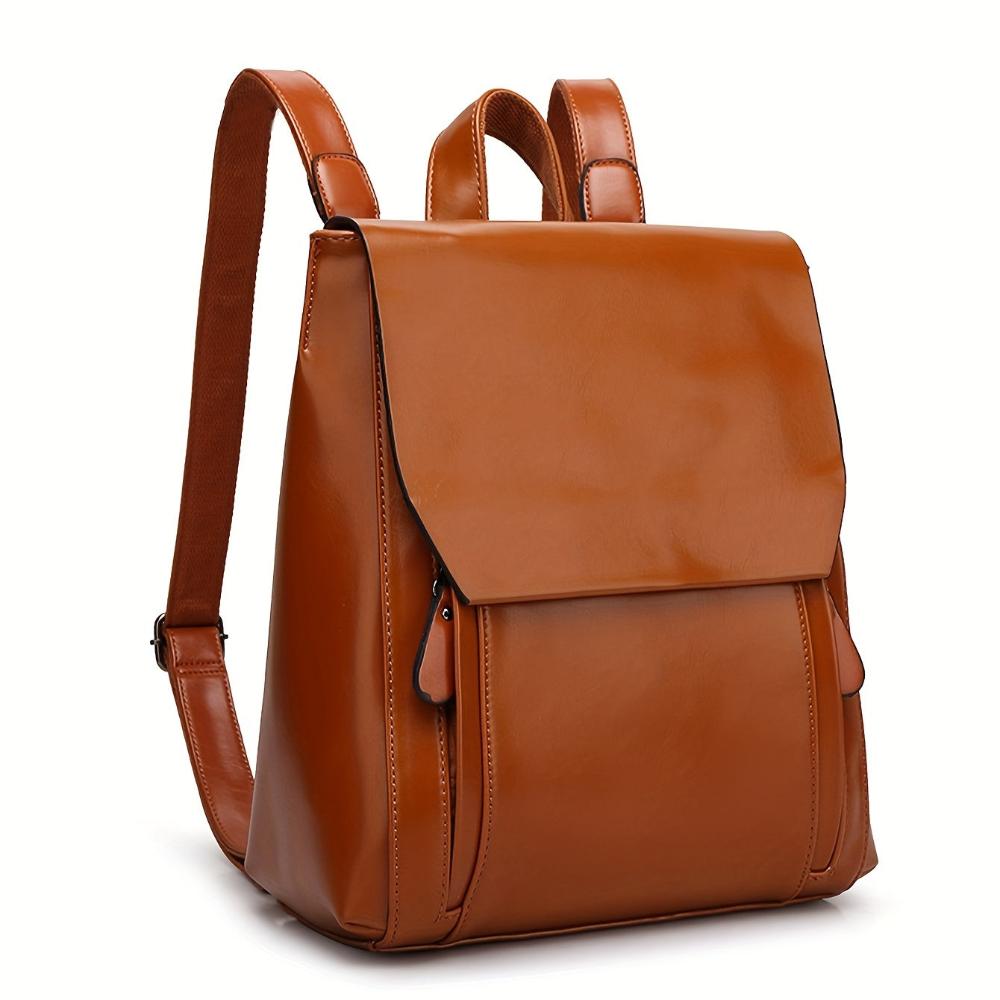 Women's black vegan leather structured backpack with flap closure and adjustable straps, sleek all-season design