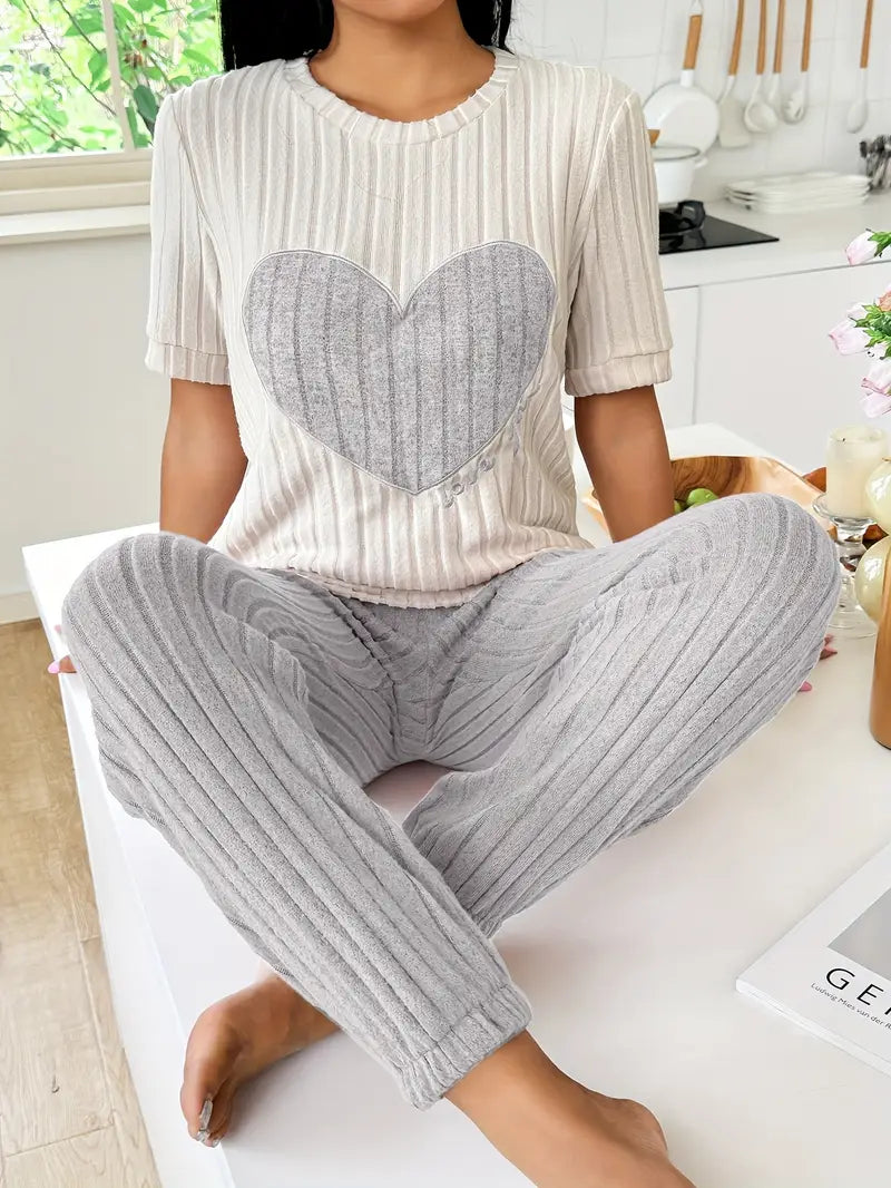 Women's pink ribbed knit loungewear set with oversized heart motif, cozy two-piece style