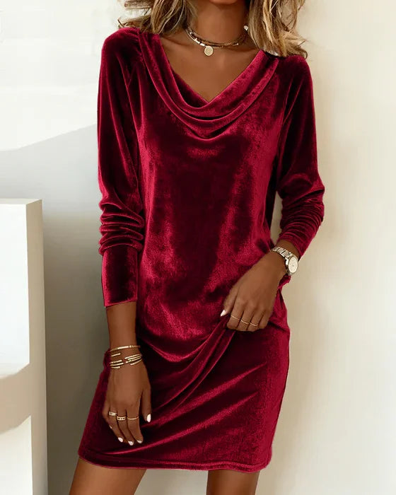 Women's black long sleeve cocktail dress with elegant draped neckline and relaxed silhouette