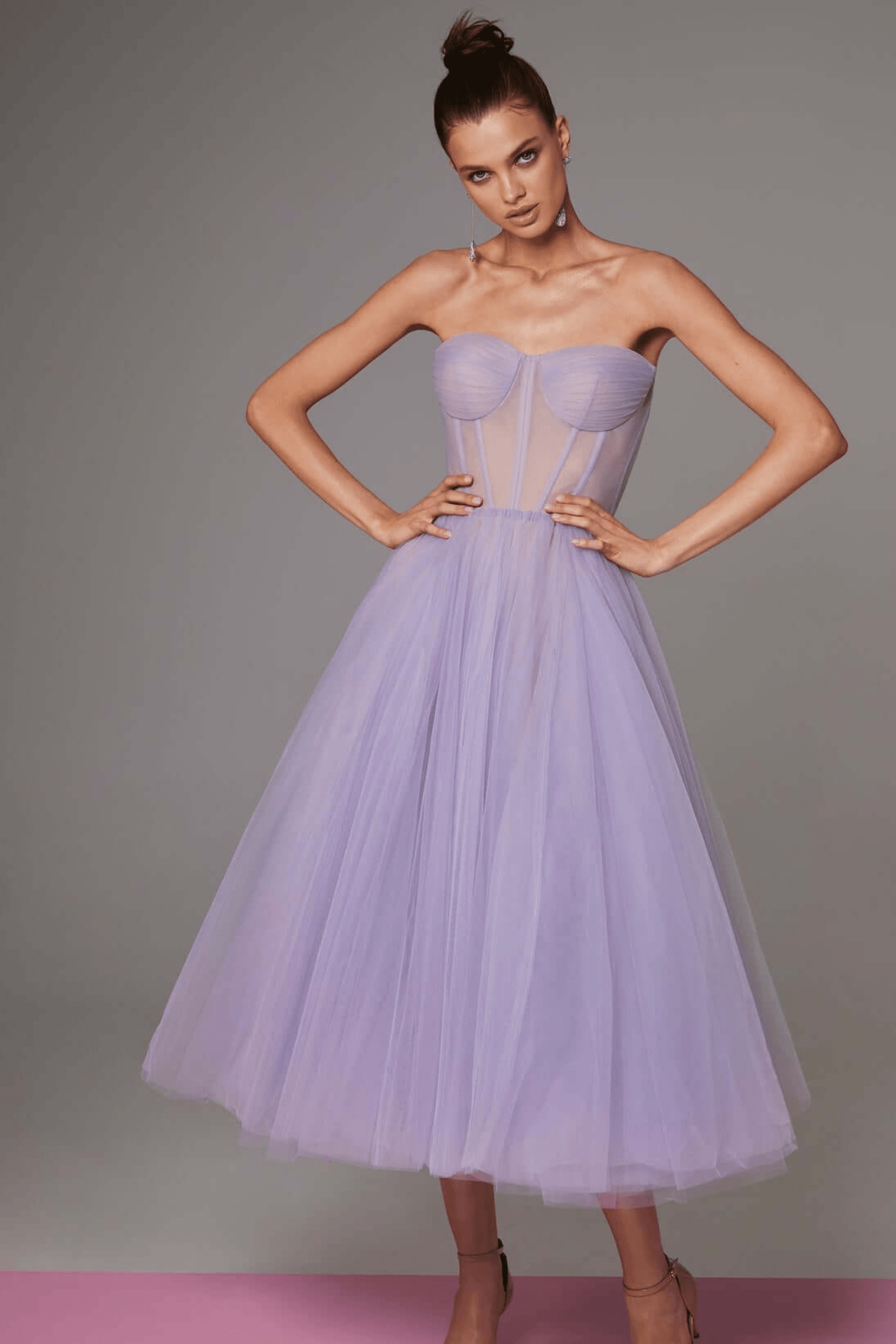 Black strapless tulle evening gown with structured bodice and voluminous multi-layer skirt