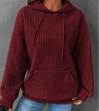 Women's loose fit hoodie with kangaroo pocket in soft textured fabric for casual everyday comfort