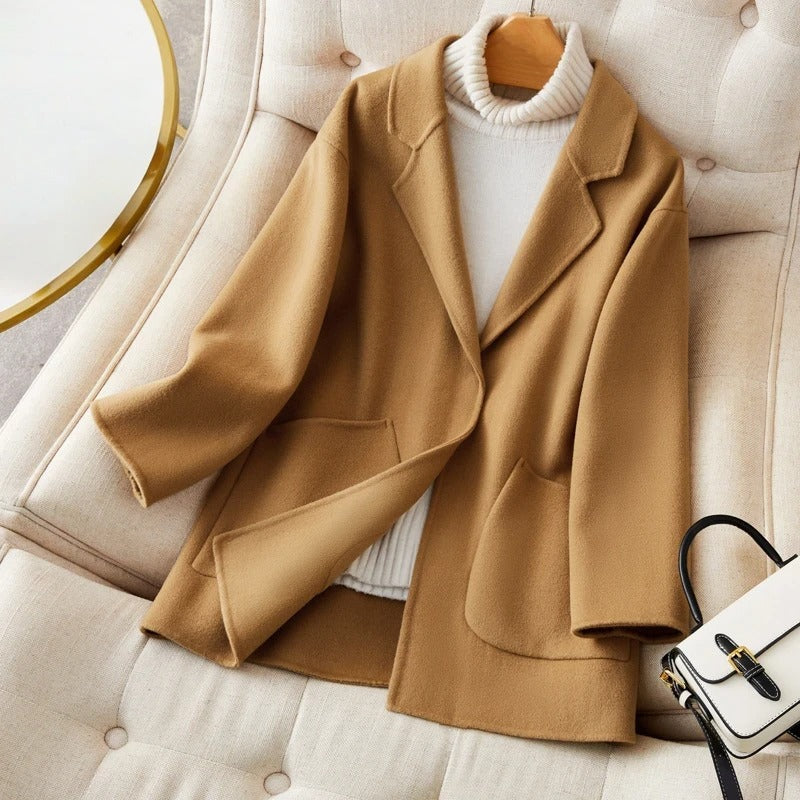 Women's relaxed fit mid-thigh wool coat in neutral tones with effortless silhouette and premium warmth