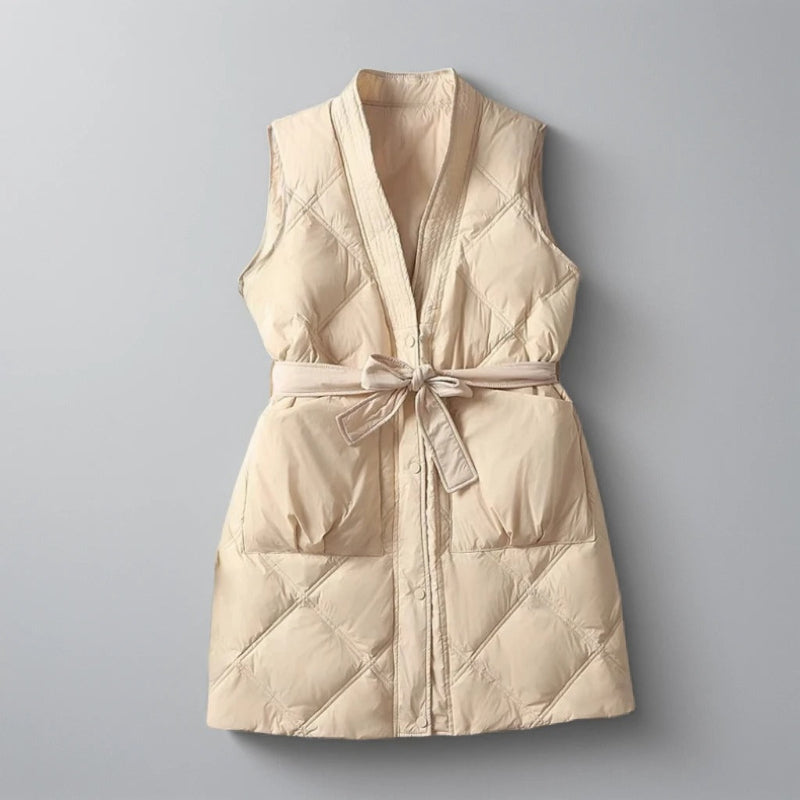 Women's black quilted mid-thigh vest with belted waist, chic layering piece for everyday wear
