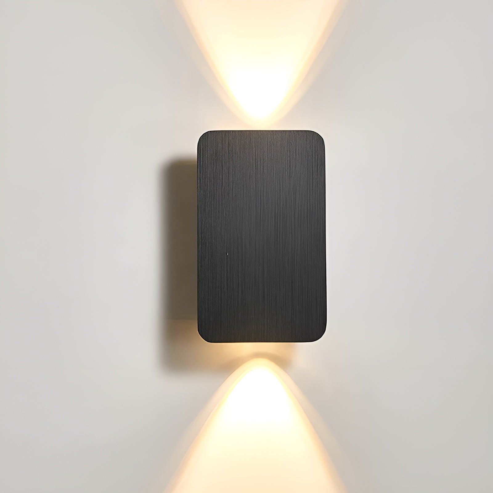 Brushed metal minimalist wall lamp with soft ambient LED glow and sleek rectangular silhouette