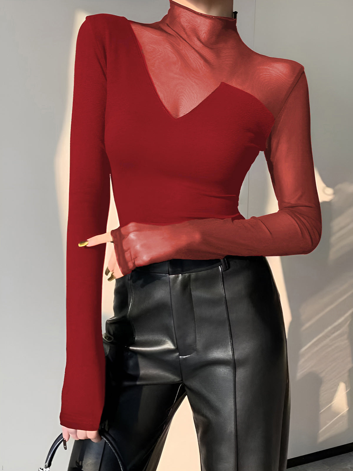 Women's black asymmetrical long sleeve top with sheer mesh panels, soft viscose cotton blend workwear style