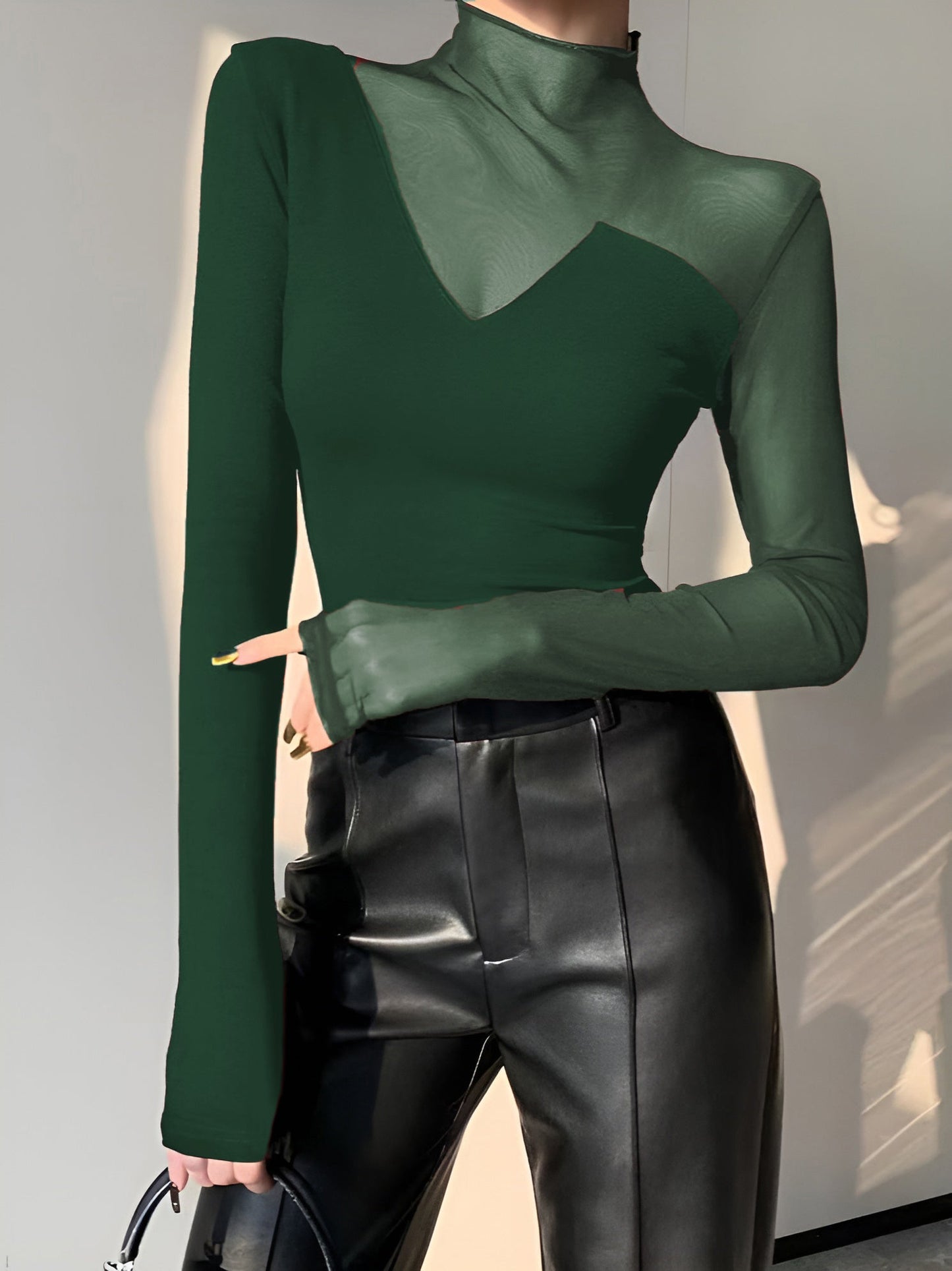 Women's black asymmetrical long sleeve top with sheer mesh panels, soft viscose cotton blend workwear tee