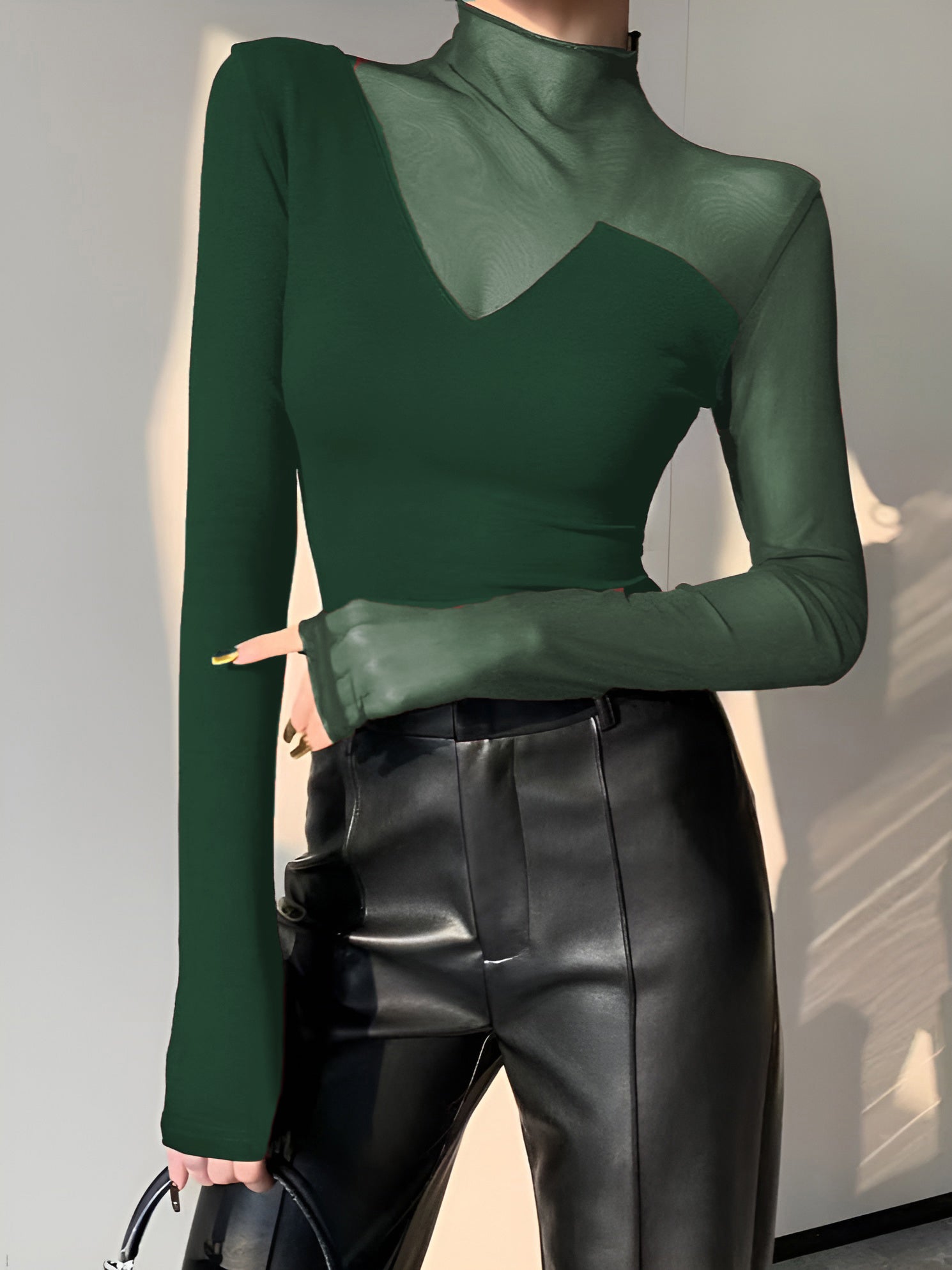 Women's black asymmetrical long sleeve top with sheer mesh panels, soft viscose cotton blend workwear tee