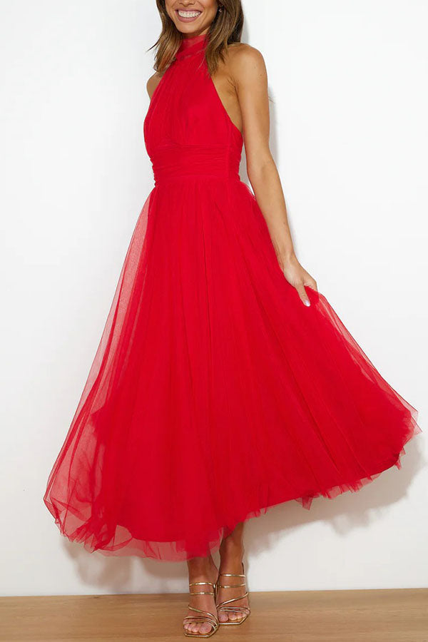 Black midi halter neck dress with open back, elegant high collar, fluid silhouette for formal occasions