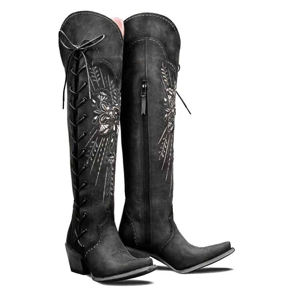 Women's vintage brown lace-up Western boots with low heel, embroidered detail, and silver rivet accents