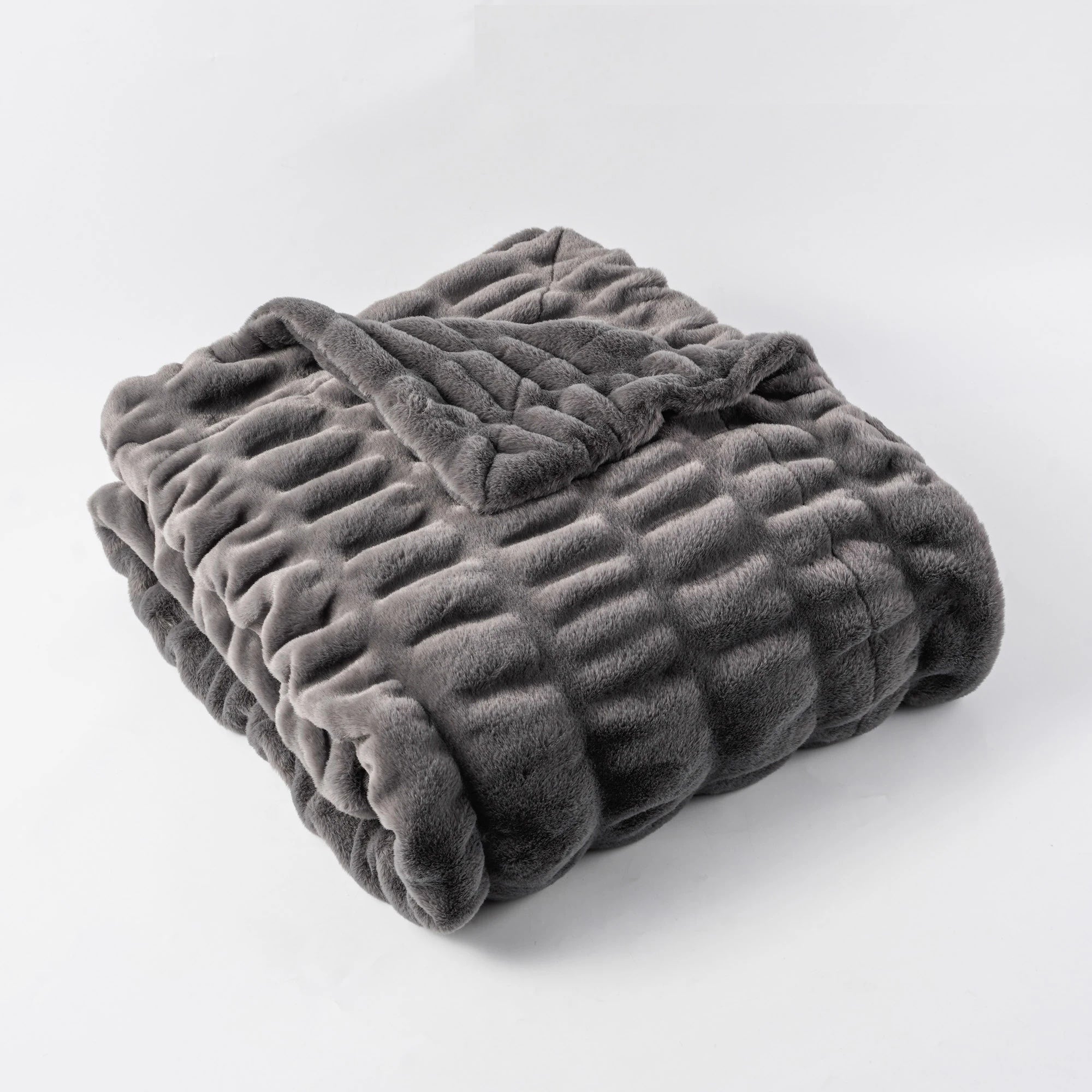Ultra-soft faux rabbit fur throw blanket in plush textured quilted design for modern living room decor