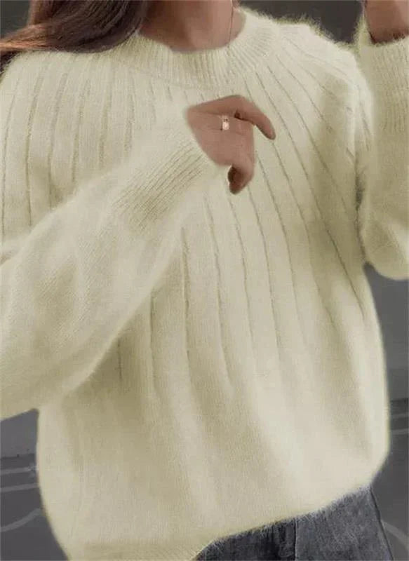 Women's fluffy knit sweater in soft neutral tone, relaxed silhouette with vertical ribbed texture