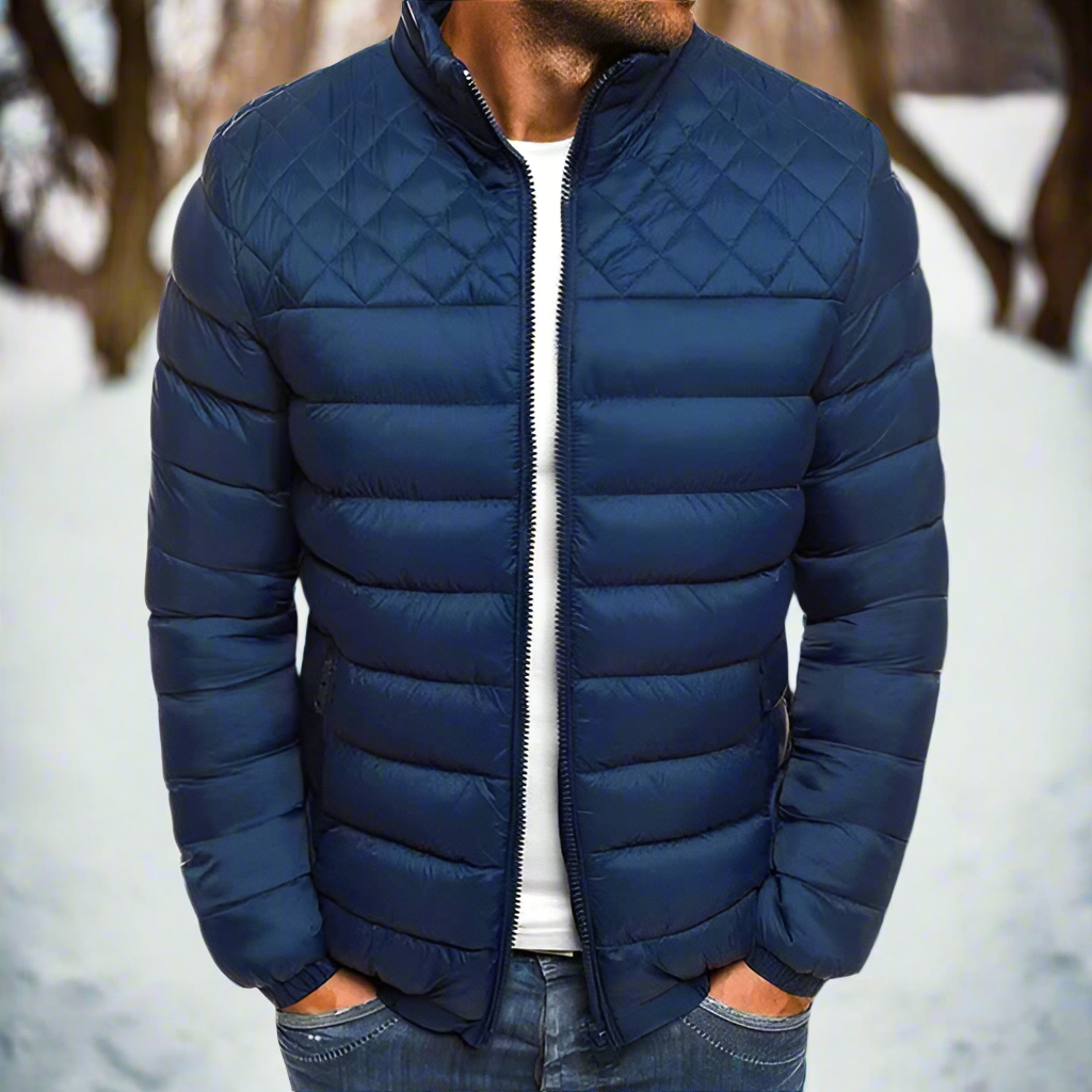 Men's navy quilted hip-length jacket with high collar, zip front, and classic diamond stitching