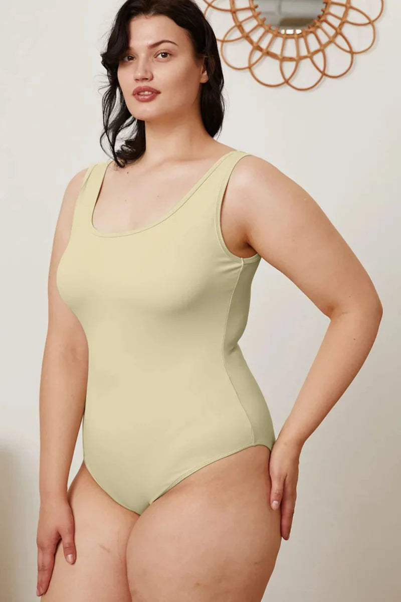 Women's sleeveless square neck bodysuit in neutral tone, slim-fit silhouette with snap closure