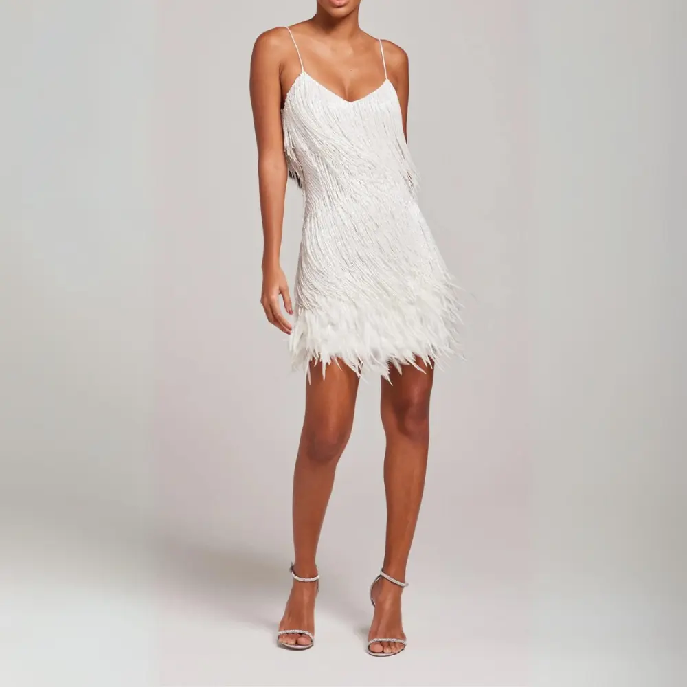Glam black mini dress with spaghetti straps, sparkling tassels and feather trim for night out