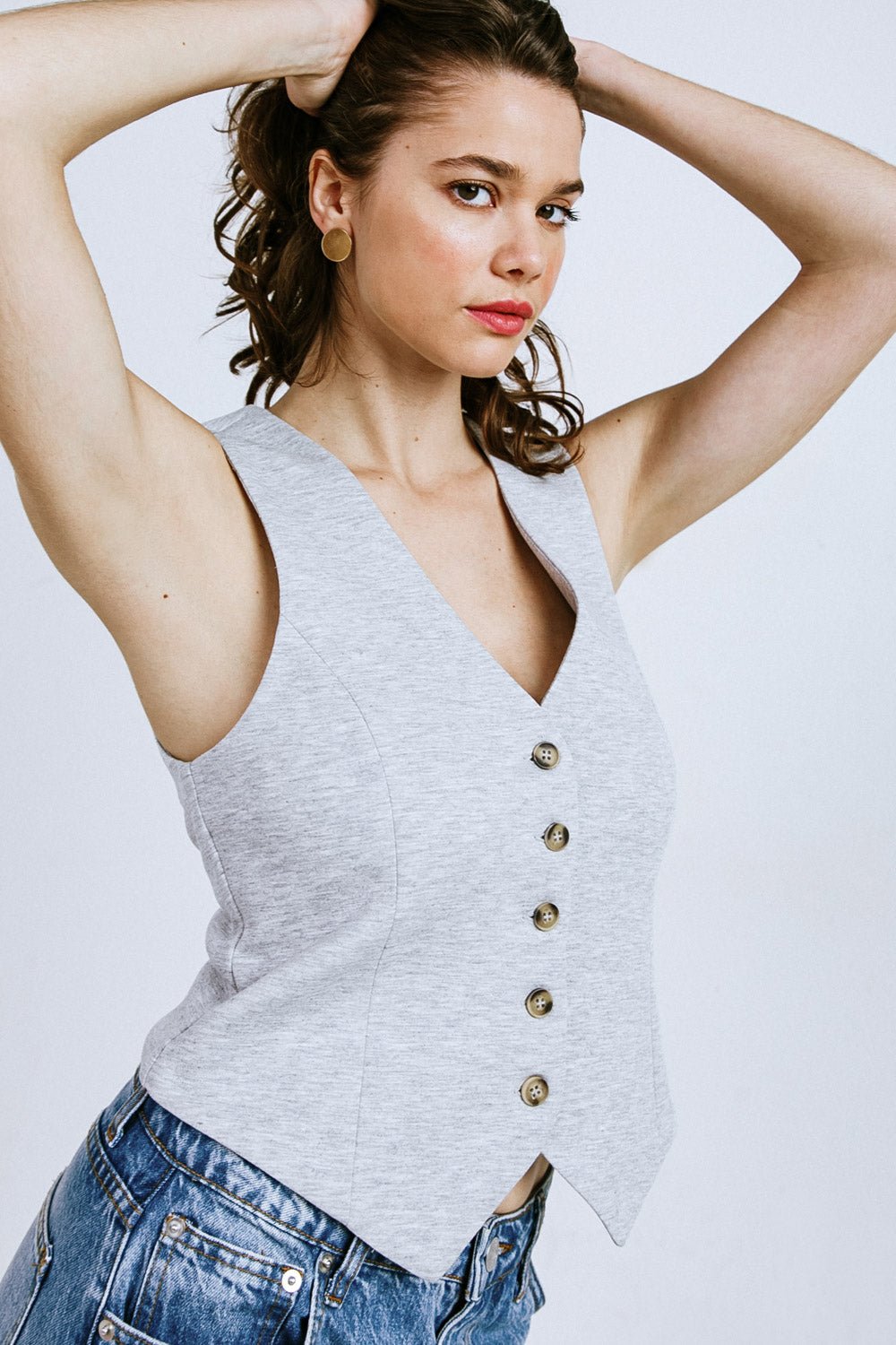 Women's elegant sleeveless vest, neutral tone, slim silhouette, refined layering piece for polished everyday style