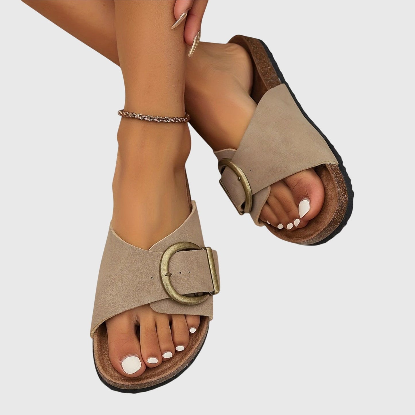 Women's slip-on sandals with wide buckle strap in neutral tone, casual open-toe design for everyday comfort