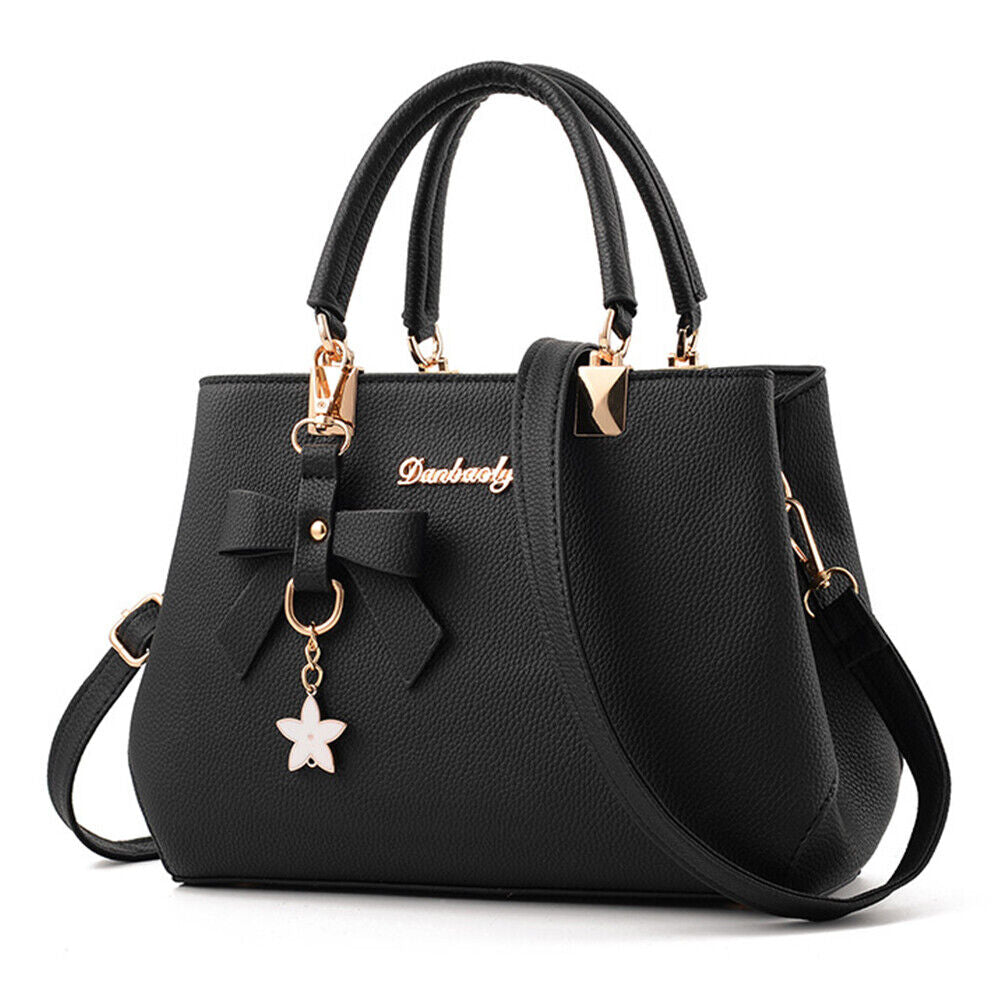 Claudete women's structured leather handbag with top handle, tassel detail, chic elegant silhouette
