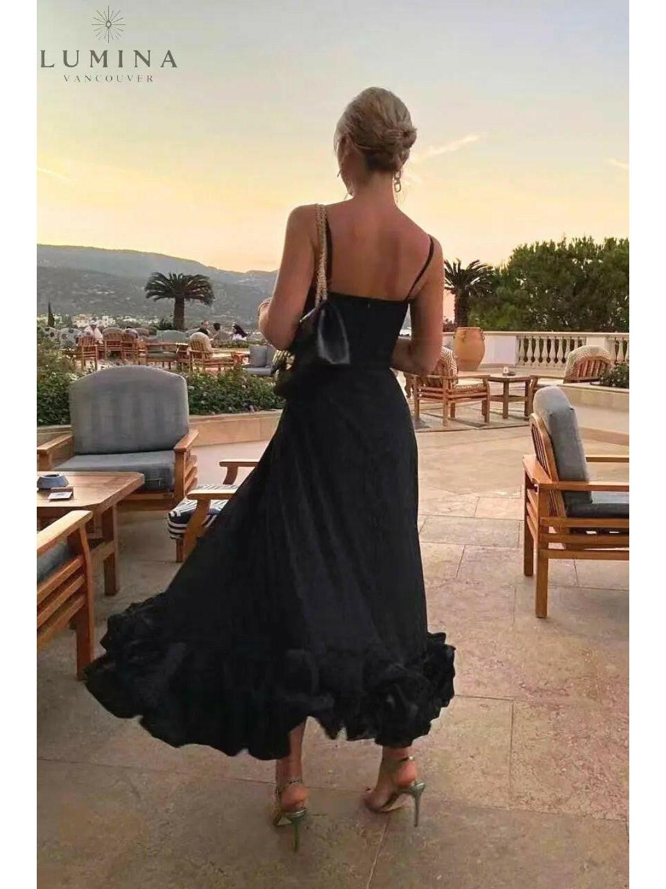 Women's elegant flowing dress in soft neutral tones with graceful silhouette perfect for wedding guest