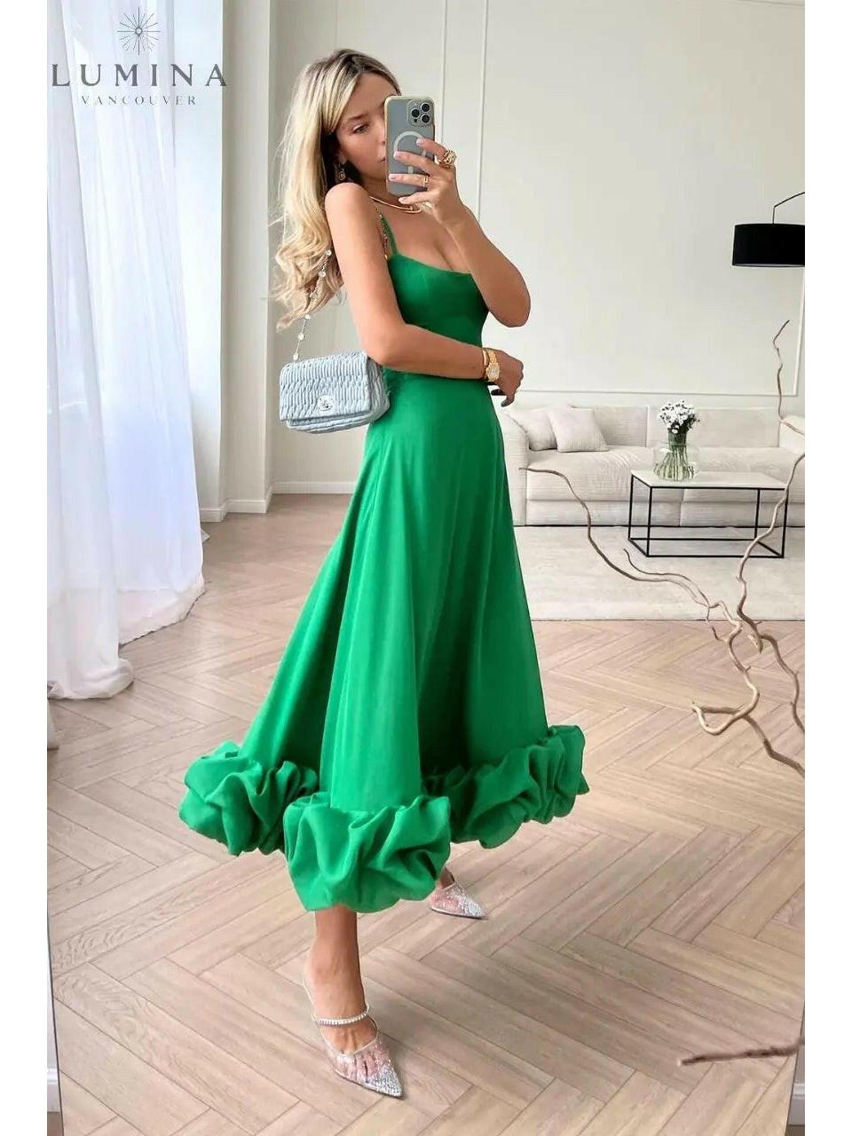 Women's elegant flowing maxi dress in soft neutral tones with graceful silhouette for wedding guest