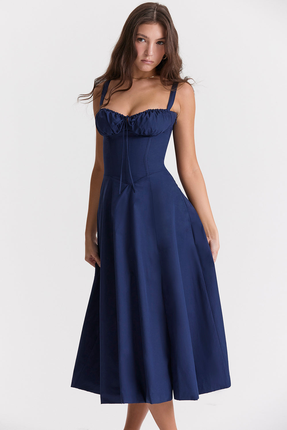 Fiery red corset midi dress with ruched detailing and flared hem, elegant sculpted silhouette