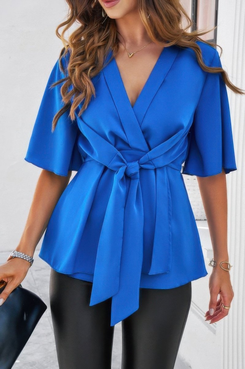 Women's white peplum blouse with V-neck tie front and bell sleeves cinched waist silhouette
