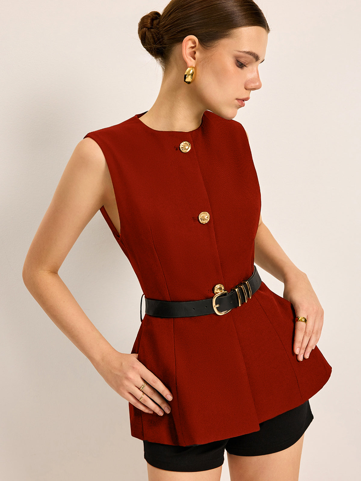Sleeveless crew neck belted top with button-accent pockets, versatile work-casual style for women