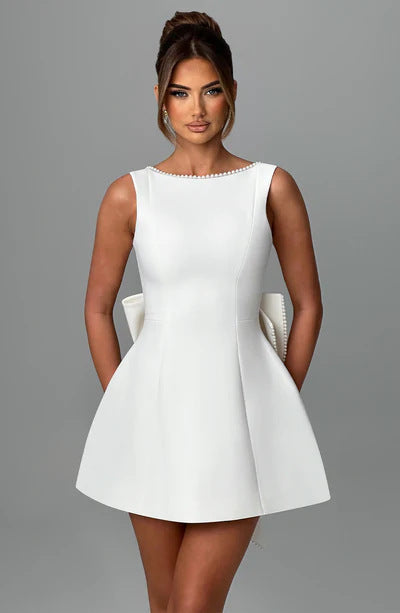 White flared mini dress with pearl accents, elegant cocktail style for special occasions