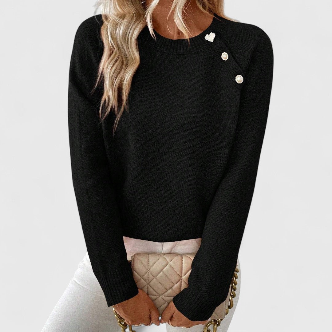 Women's cream fine-knit crewneck sweater with asymmetric pearl buttons and heart accent detail