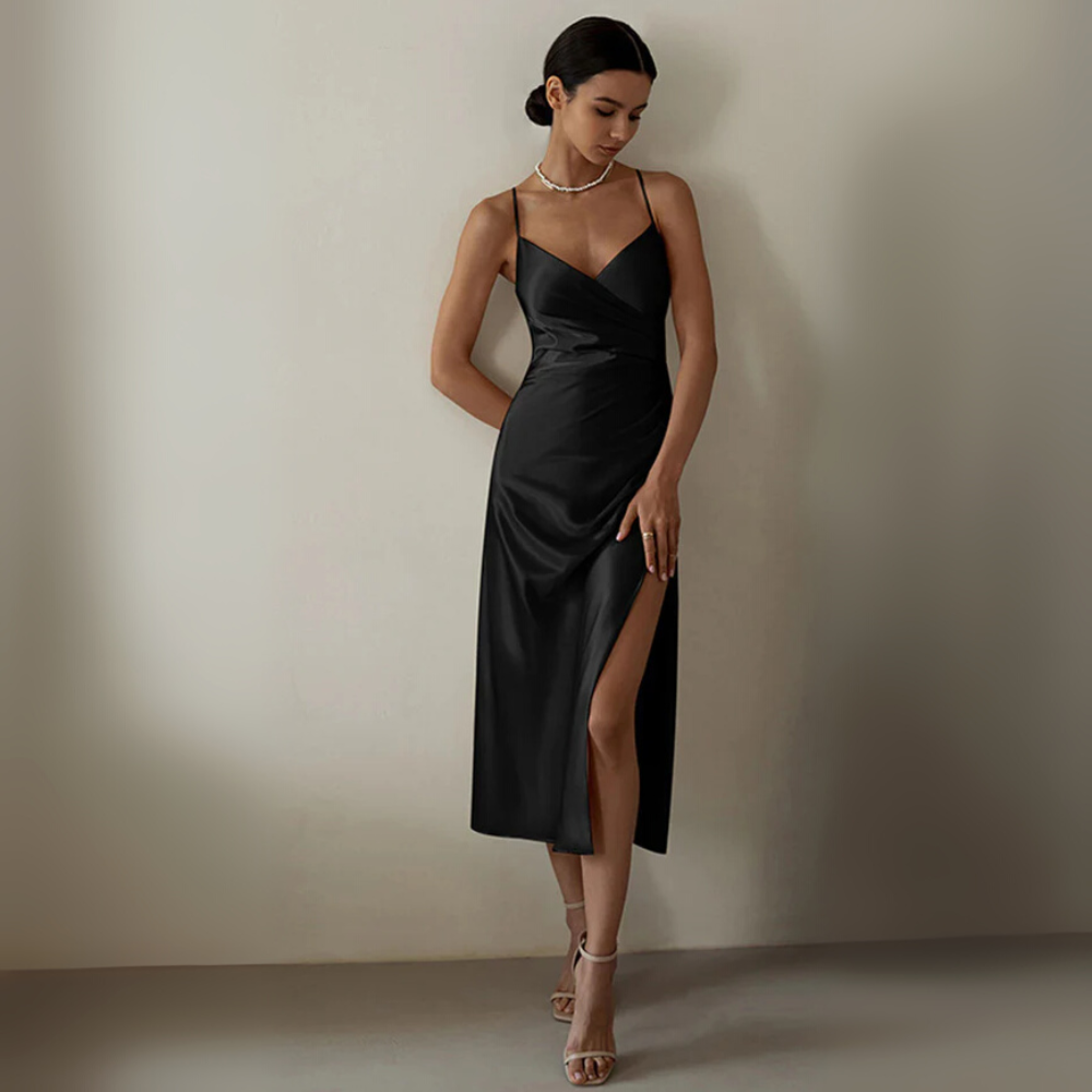 Black midi slip dress with delicate straps, fluid silhouette, and elegant side slit for women