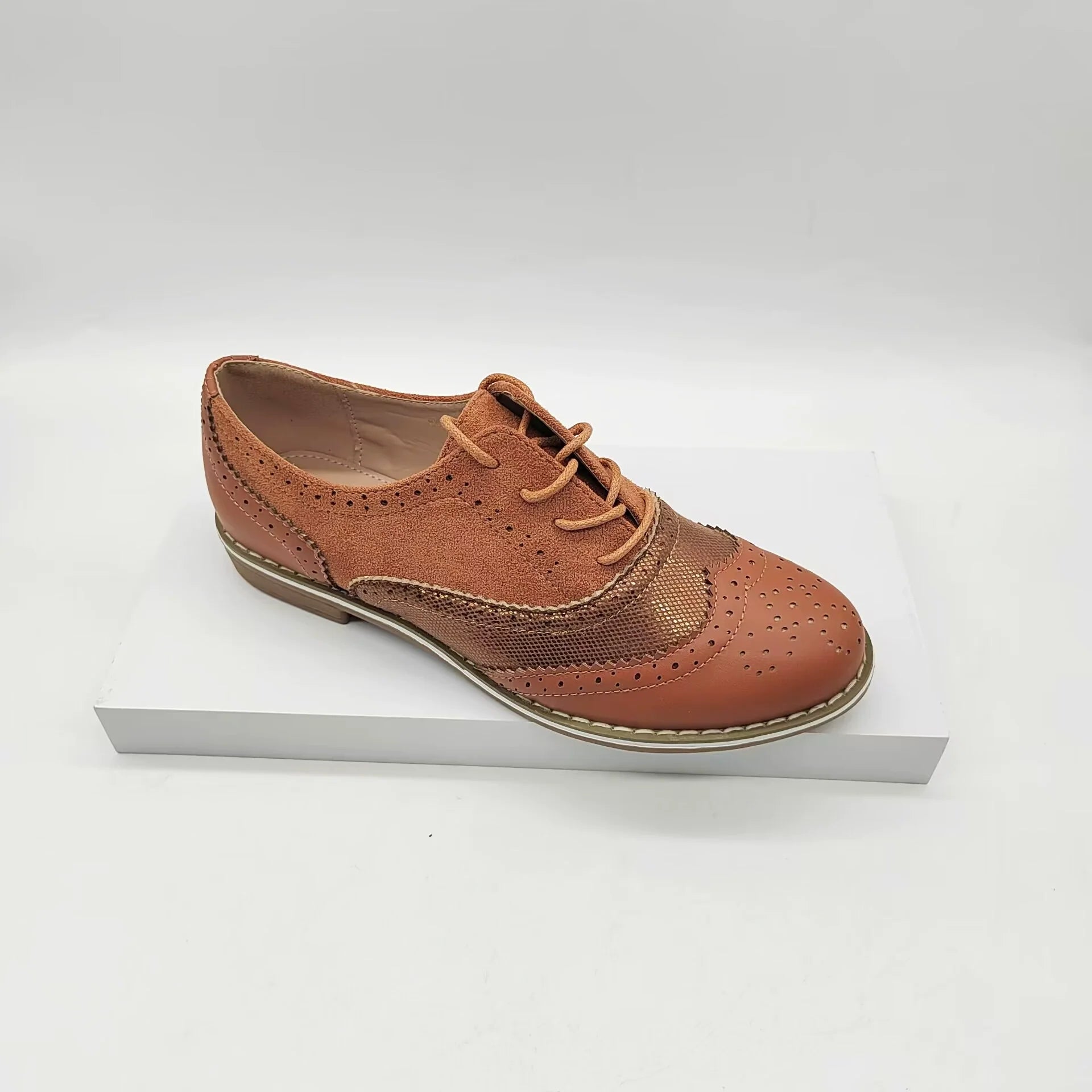 Women's brown faux leather brogue shoes with lace-up closure and classic perforated detailing