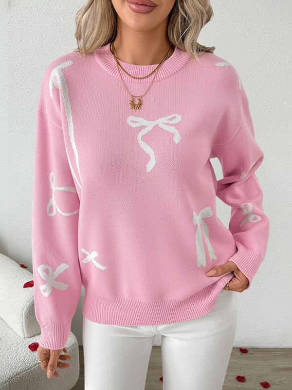 Women's holiday sweater in festive red with cozy loose-fit silhouette and playful bow jacquard graphic
