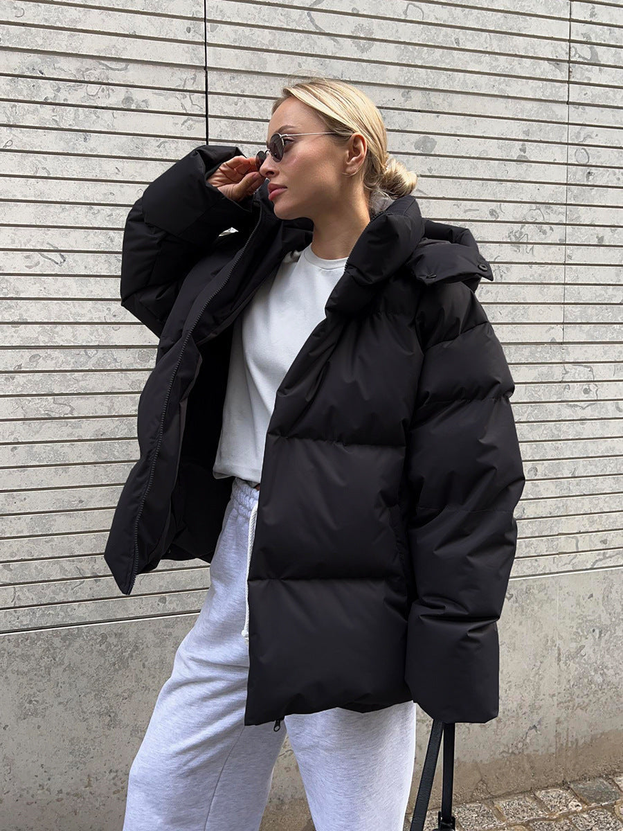 Women's oversized padded winter jacket with hood in neutral tone, cozy urban street style fit