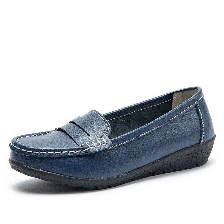 Women's black leather slip-on loafers with cushioned PU lining and flexible rubber sole for all-day comfort