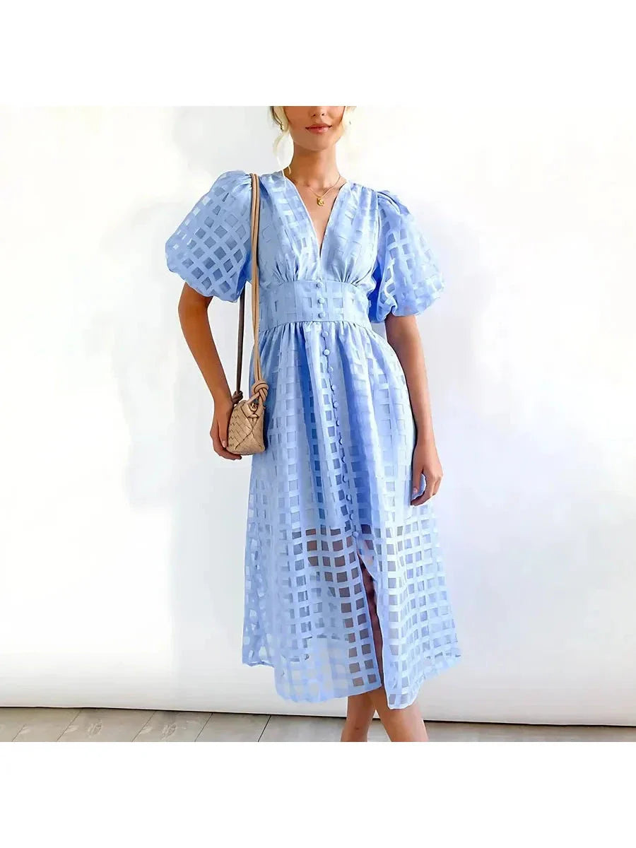 Floral patterned midi dress with puff sleeves, vintage-inspired silhouette in classic feminine print