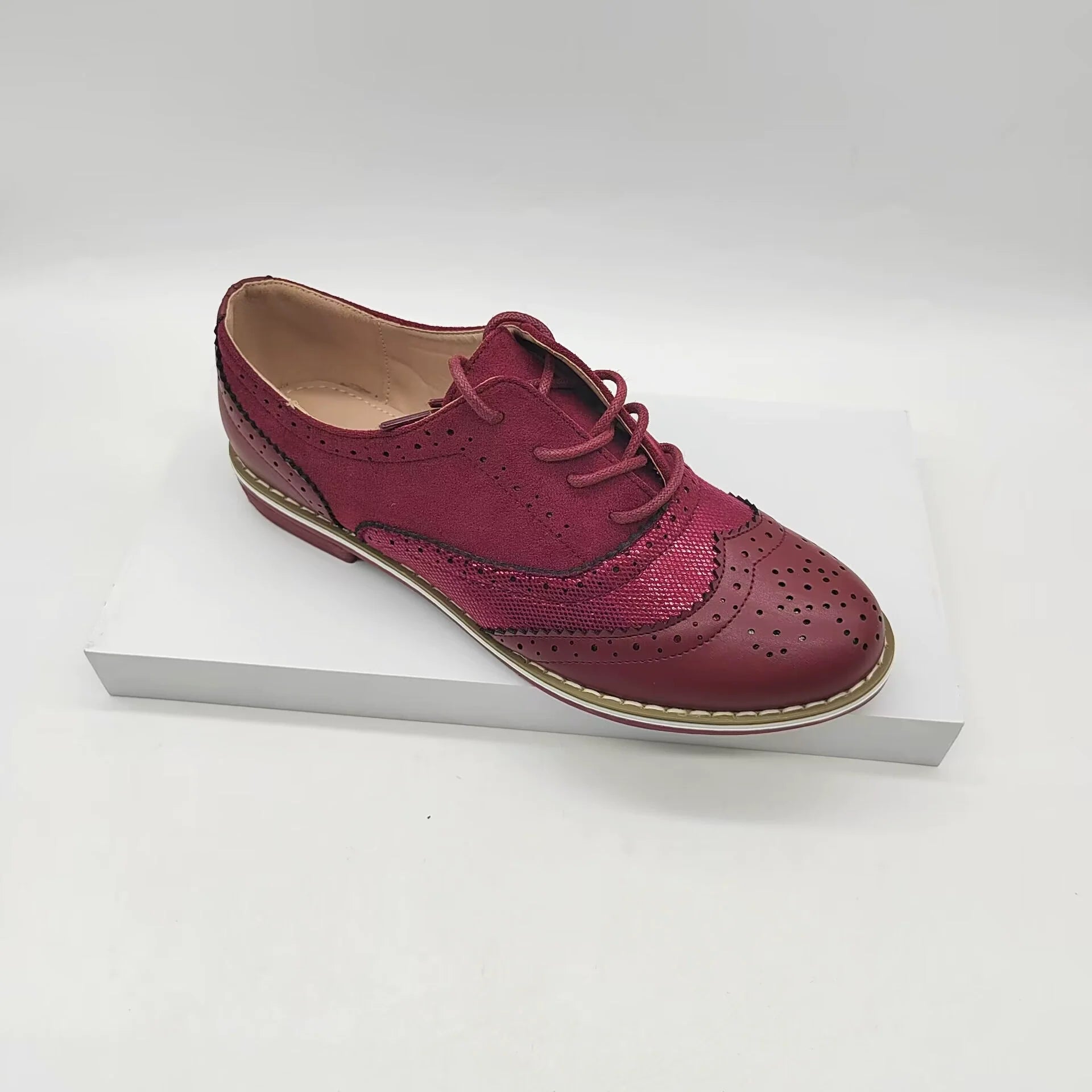 Women's brown faux leather brogue shoes with lace-up closure and classic perforated detailing