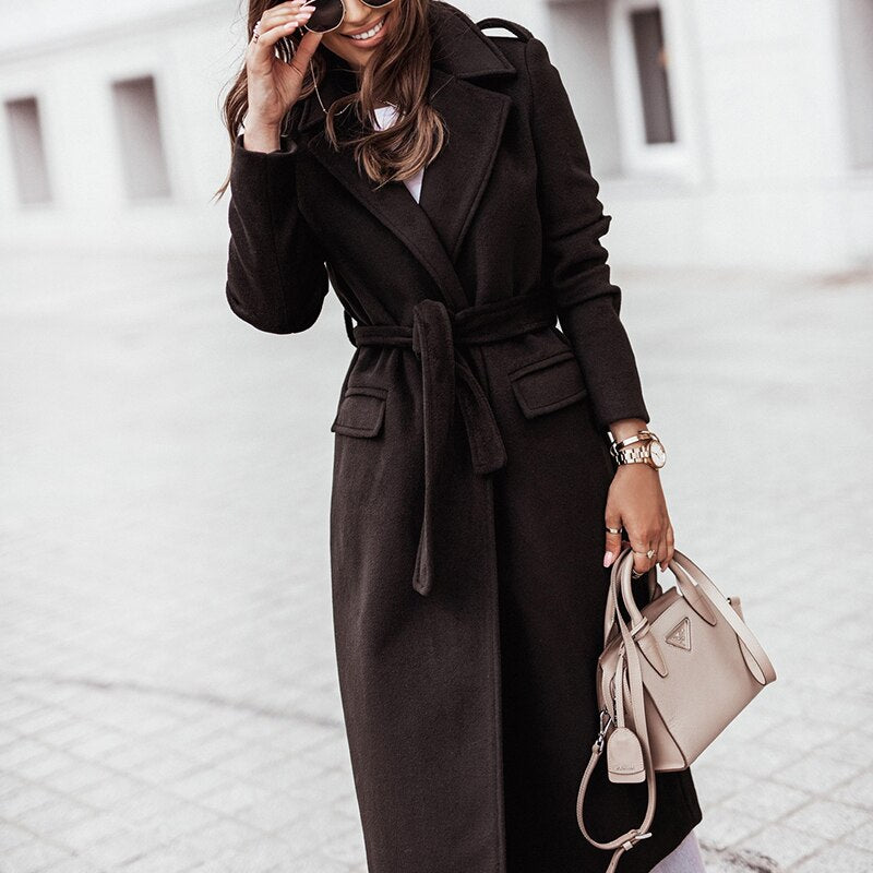 Women's long belted winter coat with hood, cozy lining, city-chic silhouette for cold weather